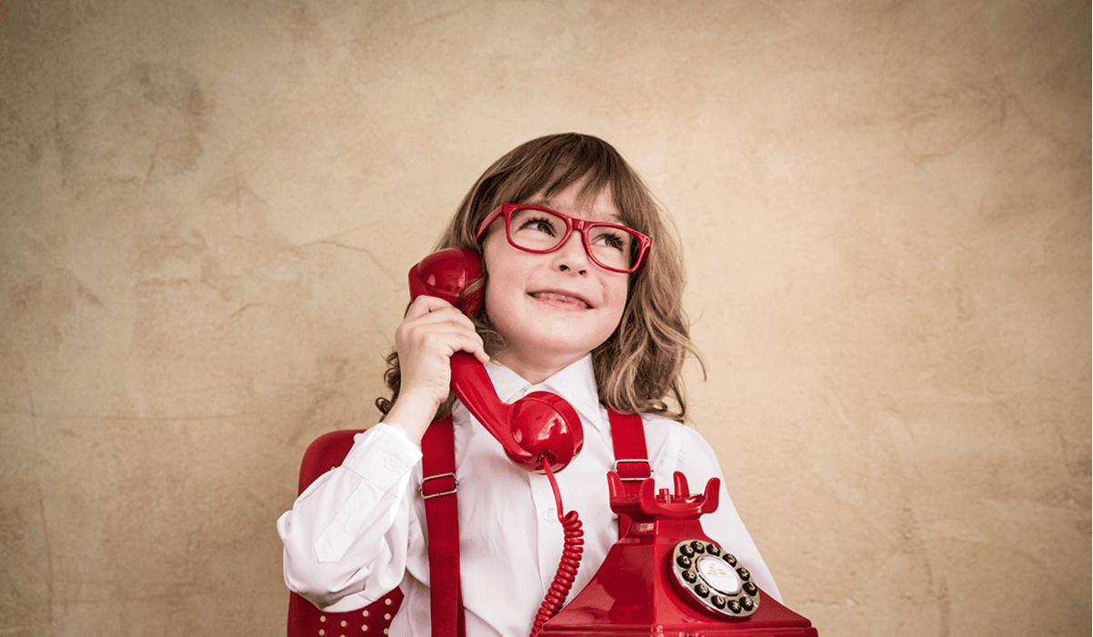 A child on the phone at Milestones Pediatric Dentistry